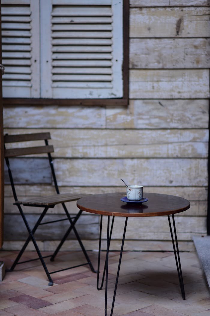 rustic-outdoor-patio-with-coffee-table-and-chair-32672477